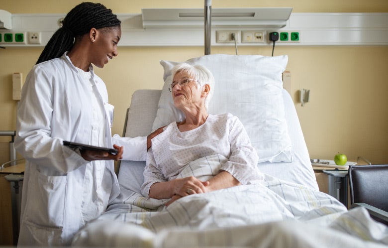 doctor comforting senior patient hospital bed blog image template    